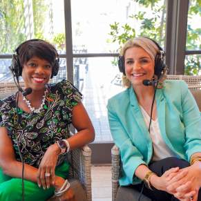 All The Waves Podcast co-hosts Zondra White Jones, left, and Katie Guasco, right, wearing headphones as they interview guests from the lobby of Southern Hotel in Covington.