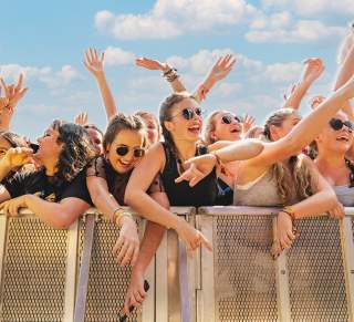 Crowd of young women against the festival barricade in front of stage at ACL Music Festival