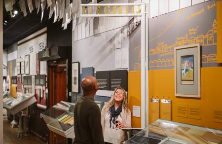 Couple exploring the Dylan Thomas Centre exhibition in the dylan thomas centre