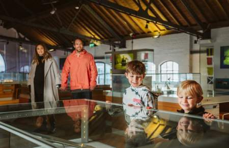 Two parents with two children in a museum