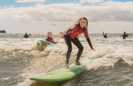 young girls surfing in rhossili bay