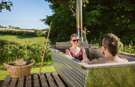 couple relaxing in outdoor hot tub