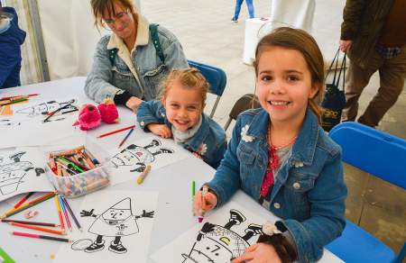 Children colouring in on a craft table.