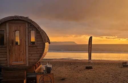 Small round wooden sauna on the beach