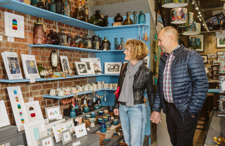 A man and woman browsing in a craft shop.