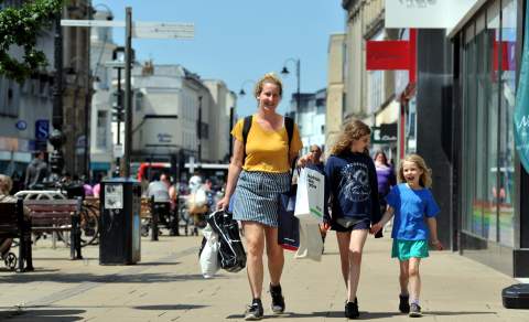 A family shopping on the High Street in Cheltenham.
