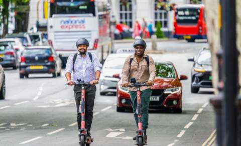 Visitors riding electric scooters down the Promenade in Cheltenham.