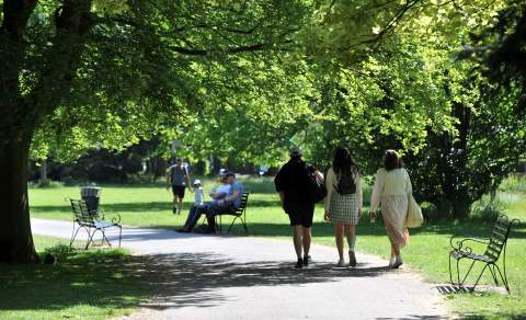 People walking through Cheltenham parks and gardens.
