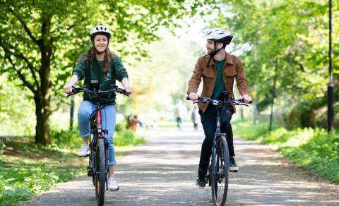 Visitors cycling through Cheltenham.