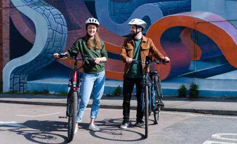Visitors riding bikes in Cheltenham.