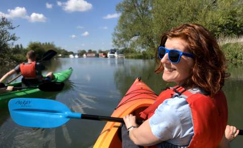 A couple kayaking on the River Thames at Lechlade with Cotswold Canoe Hire