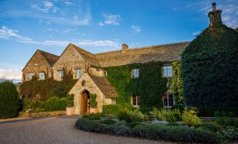 A gravel driveway leads to the stunning main building at Calcot & Spa