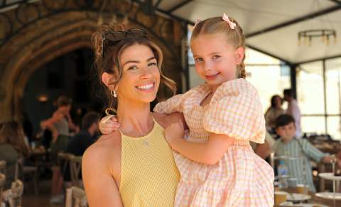 Mother holding her child in her arms, both smiling