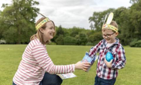 a woman and a child wearing easter bunny ears at buckfast abbey