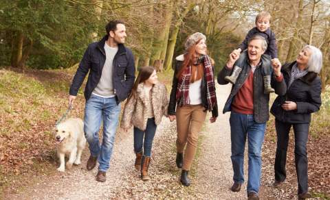family walking a dog in autumn