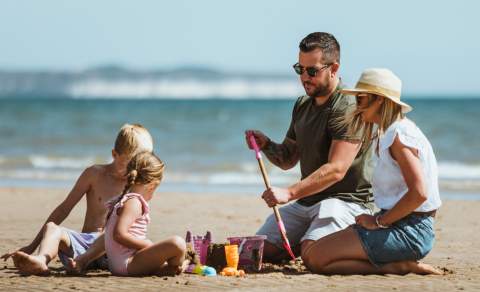 A family build sandcastles on the beach in Bridlington, East Yorkshire