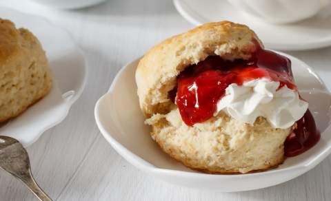 A scone filled with jam and cream