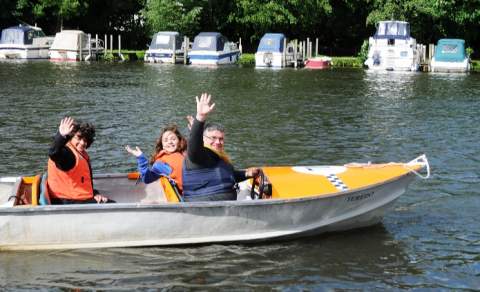 Family in a motor boat on the Thames at Henley