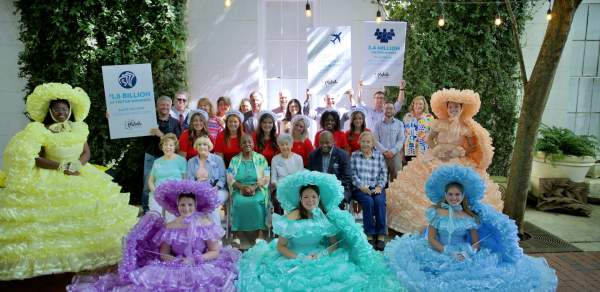 group of people standing among five Azalea Trail Maids in Antebellum dresses