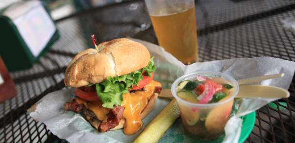 Bacon Cheeseburger, pickle spear, cup of tomato and cucumber salad