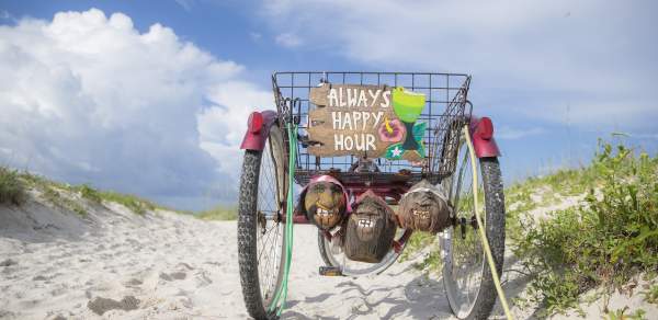 Old, three wheel bicycle parked on the beach