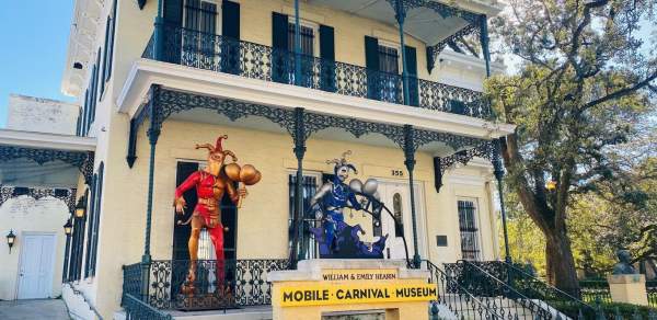 Mardi Gras Museum exterior with two jester statues