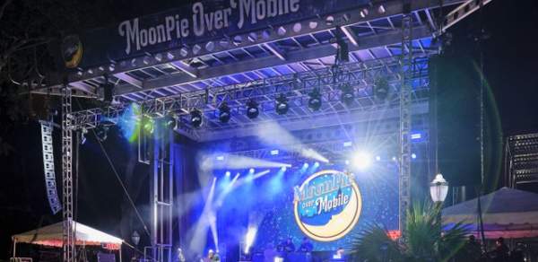 Large stage with musical acts, lights and MoonPie Over Mobile logo