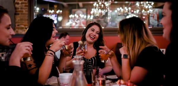 group of women drinking cocktails in a restaurant