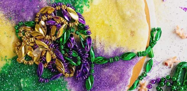multi colored pastry with Mardi Gras beads on top
