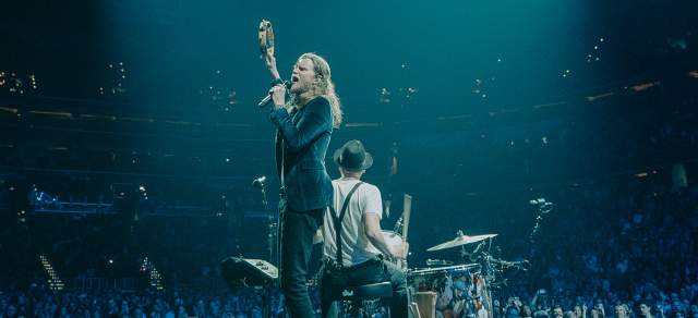 The Lumineers perform on stage.