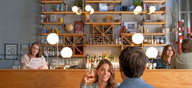 A couple eating at The Greenwich in Denver, Colorado.