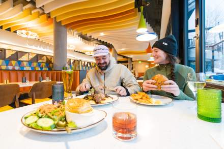 A couple eating at Seventy One with plates and drinks on the table in front of them.