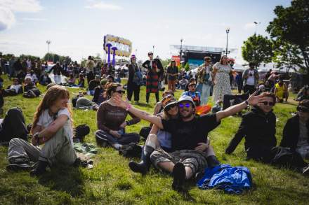 People sitting on the grass at Kilby Block Party.
