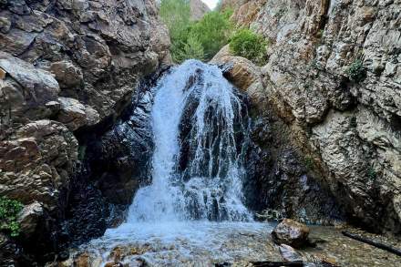 Waterfall with high rocky canyon walls on each side
