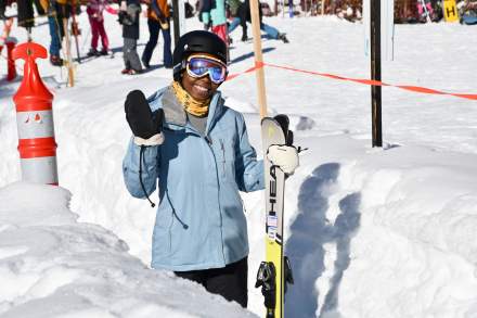 A skier rides the magic carpet lift at Brighton Resort