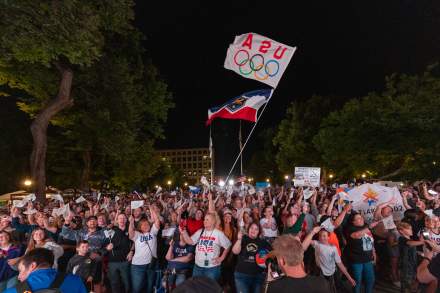 People cheering in Washington Square Park in Downtown Salt Lake. The crowd is cheering for the 2034 Olympic announcement.