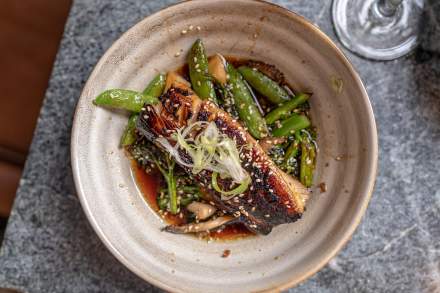 Plate of Fish with sugar snap peas and sauce at Franklin Ave Cocktails & Kitchen