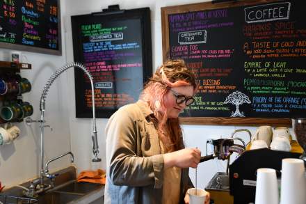 Raelle Westwind making a drink in the coffee shop at The Legendarium