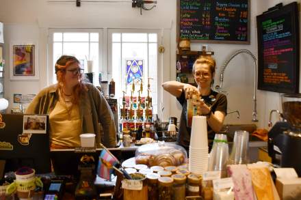 Raelle and Orion behind the coffee counter at The Legendarium