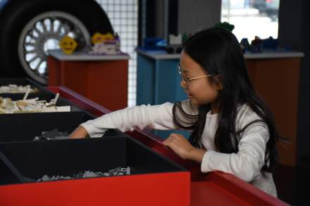 A child playing with legos at the leonardo