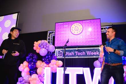 Speakers on stage at a conference at the Salt Palace Convention Center.