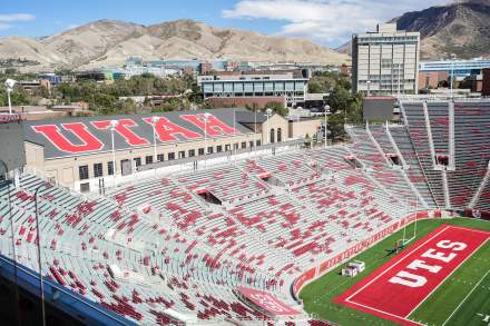 An aerial view of Rice Eccles Stadium showing the mountains in the background and the top row showing Utah and the field showing Utes
