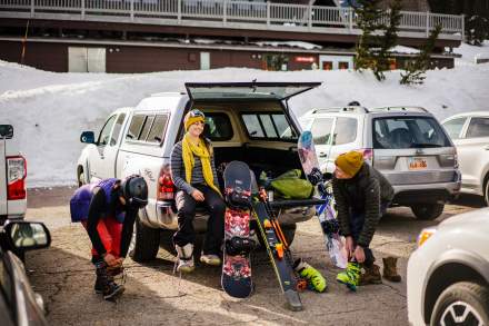Friends getting ready in parking lot to ski at Brighton