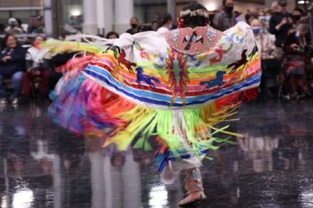 A performer at Utah Division of Indian Affairs’ Utah Indigenous Day Social Powwow dons a colorful garment as they dance.