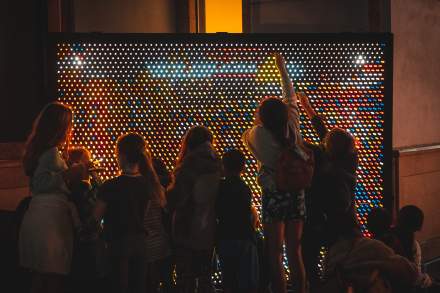 Children play with an interactive light exhibit at ILLUMINATE.