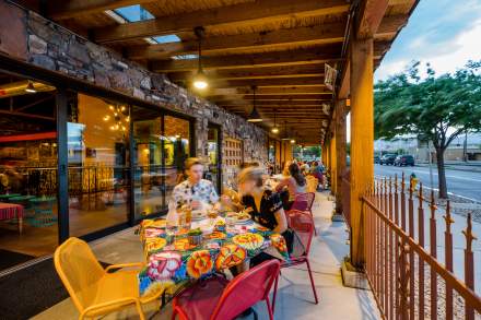 Image of people eating on the patio of Red Iguana 2