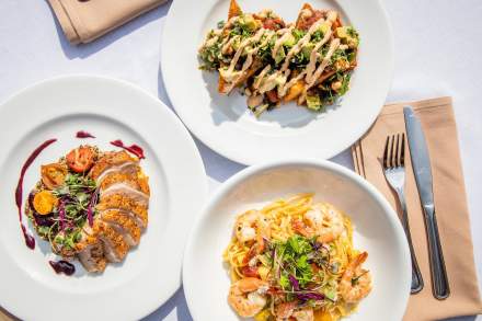 3 course meal on 3 plates with fork and knife on a cloth napkin