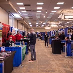 line of tradeshow booths and attendees during and expo