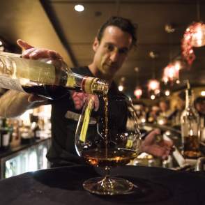 Bartender Pouring A Drink During Happy Hour At Ace Gilletts In Fort Collins, CO