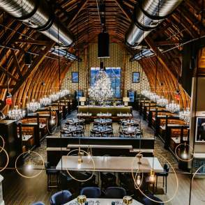 Interior view of Black Sheep Restaurant with tables and chandeliers
